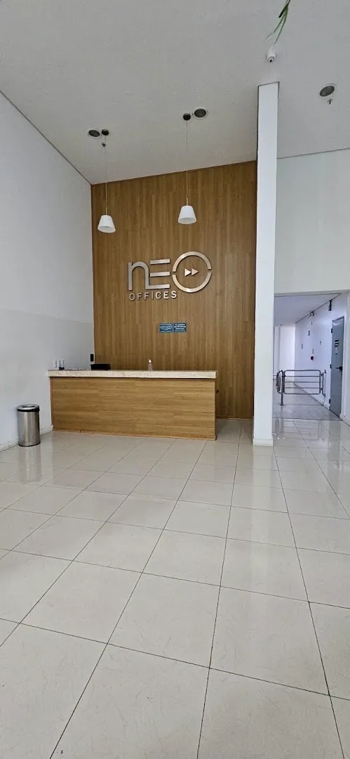 Recepção do Edifício Neo com painel de madeira e o logo 'neo'